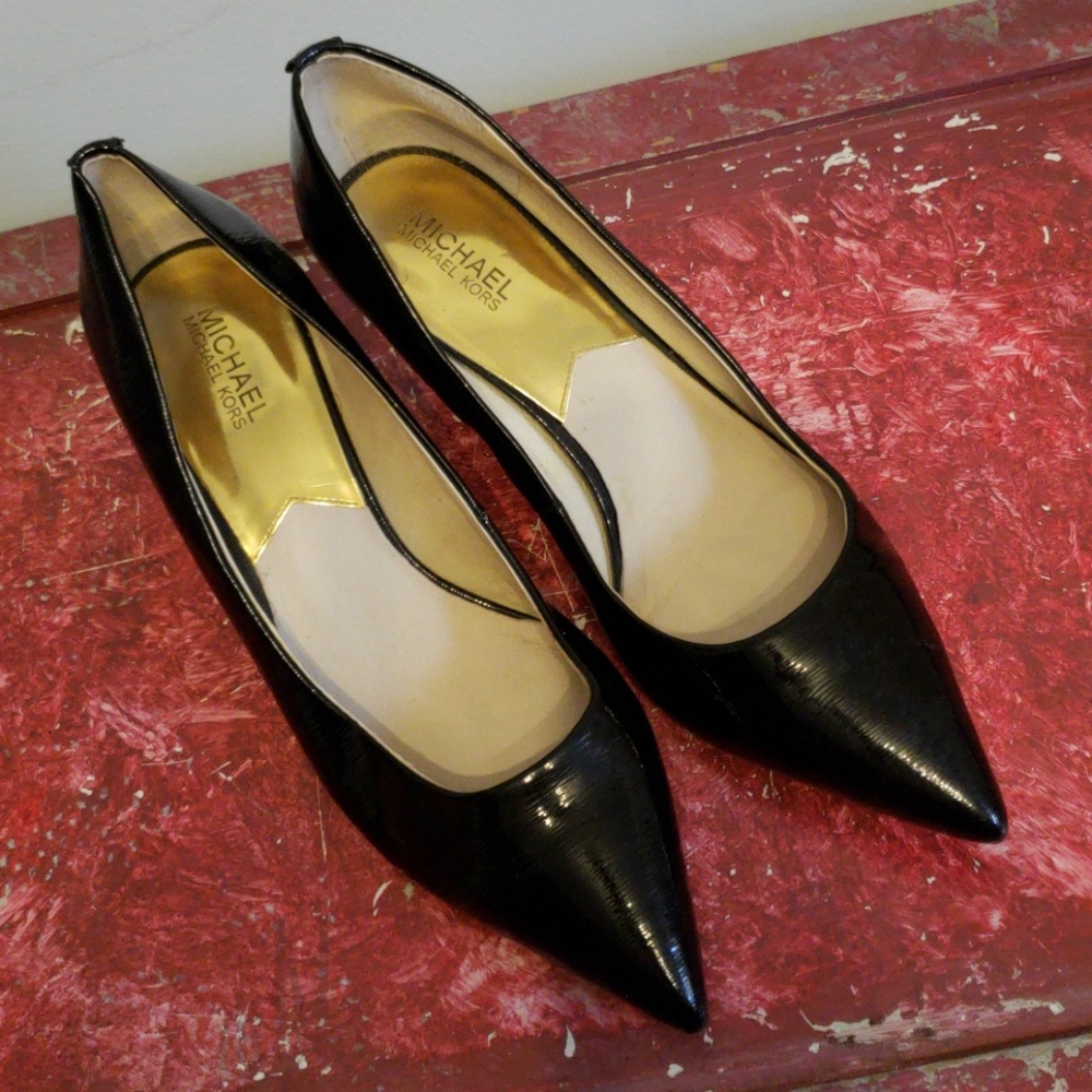 Black textured patent leather kitten heels.